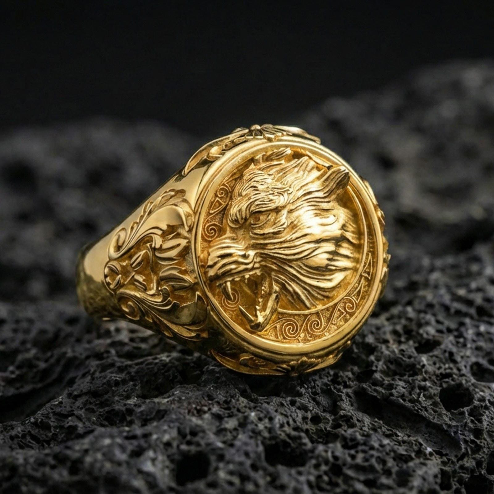 Fenrir wolf of the moon ring in a gold plated finish on volcanic rock, bold Viking mythology wolf emblem design, premium macro product image