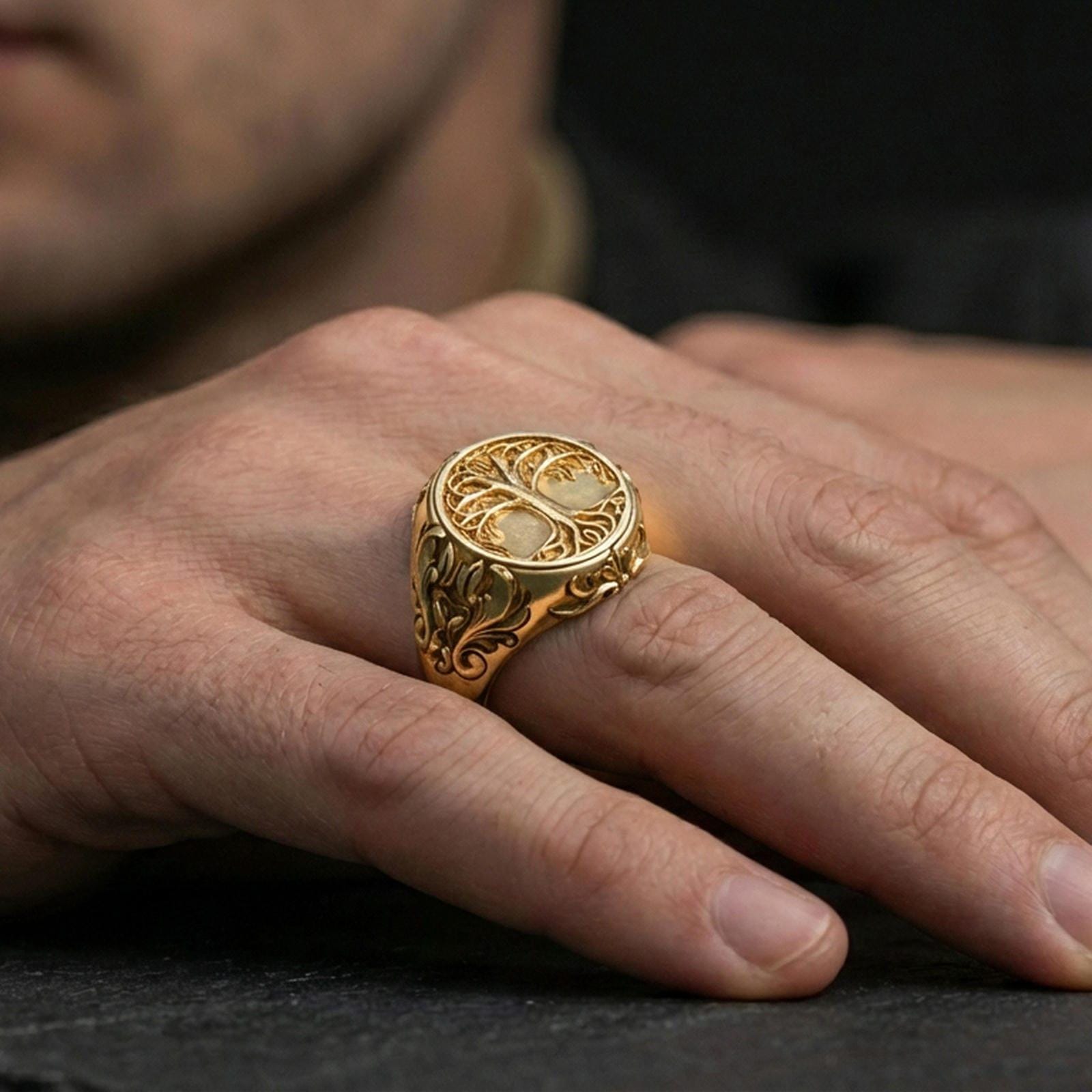 Tree of life Yggdrasil ring in a gold plated finish worn on finger, bold symbolic signet style with engraved side details, premium lifestyle close-up