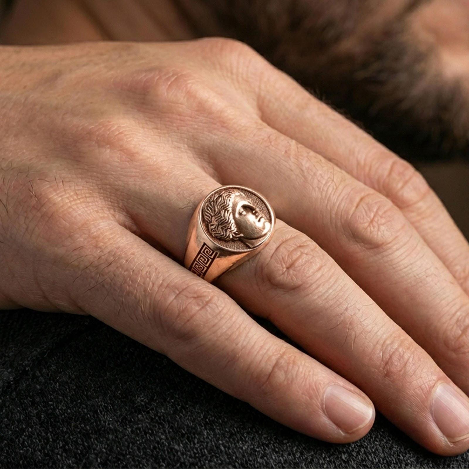 Venus astrological feminine symbol ring in a rose gold plated finish on finger, vintage Roman portrait signet style, close-up hand shot