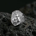 Load image into Gallery viewer, Anubis signet ring in polished silver finish on volcanic rock, raised jackal head emblem framed by geometric border, premium close-up
