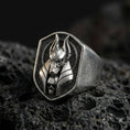 Load image into Gallery viewer, Sterling silver Anubis ring in an oxidized finish on volcanic rock, jackal-headed Egyptian god relief with skull accent, sharp macro studio shot
