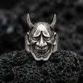 Load image into Gallery viewer, Sterling silver Hannya mask ring in an oxidized finish on volcanic rock, Japanese demon face with horns and grim expression, macro studio shot
