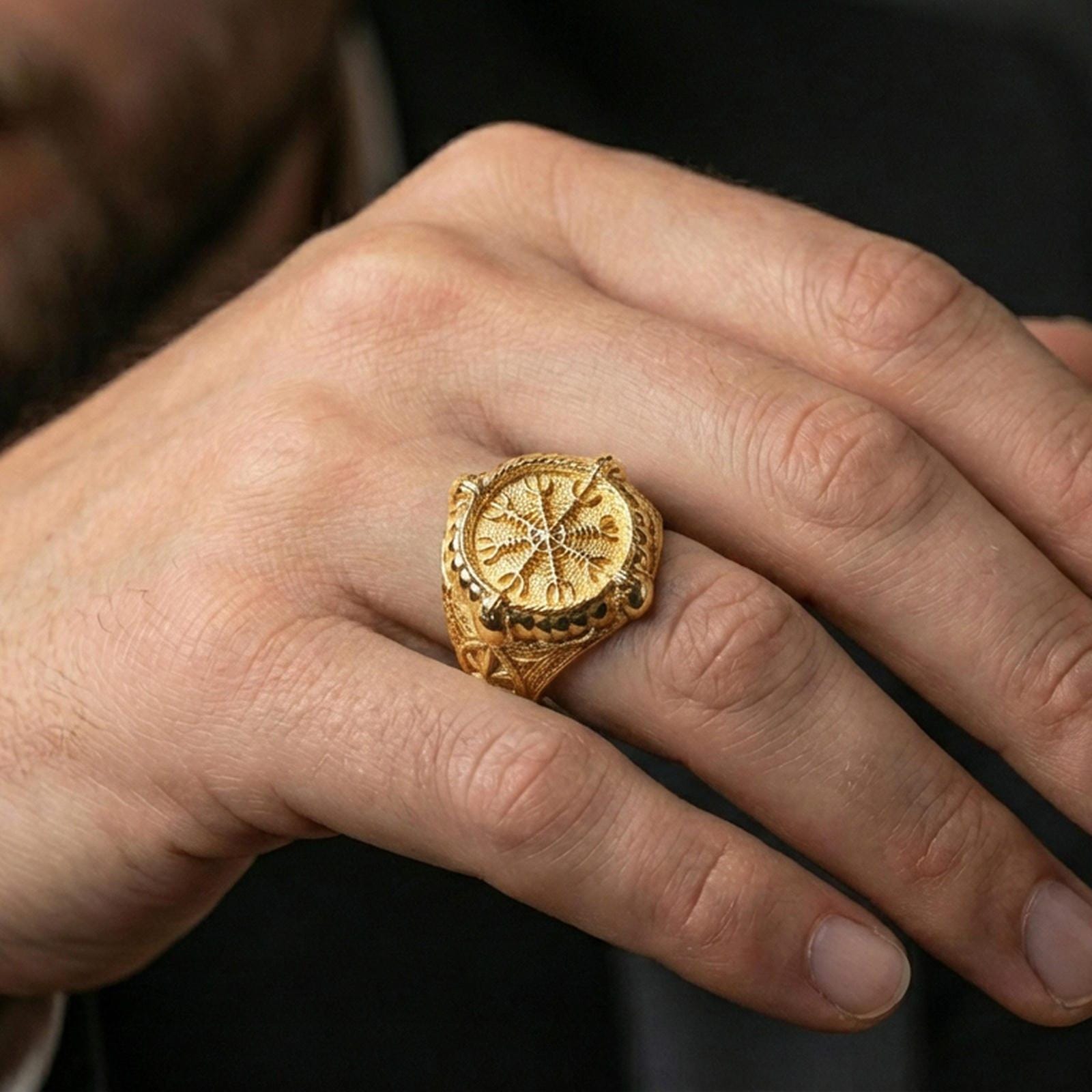 Viking compass Vegvisir ring in a gold plated finish worn on finger, Nordic rune symbol signet style, premium lifestyle close-up