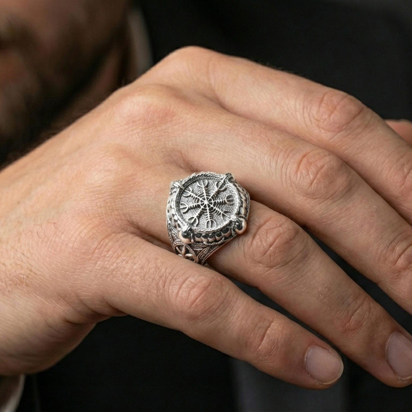 Vegvisir signet ring in polished silver finish on hand, crisp rune compass engraving with reflective highlights, lifestyle jewelry photo