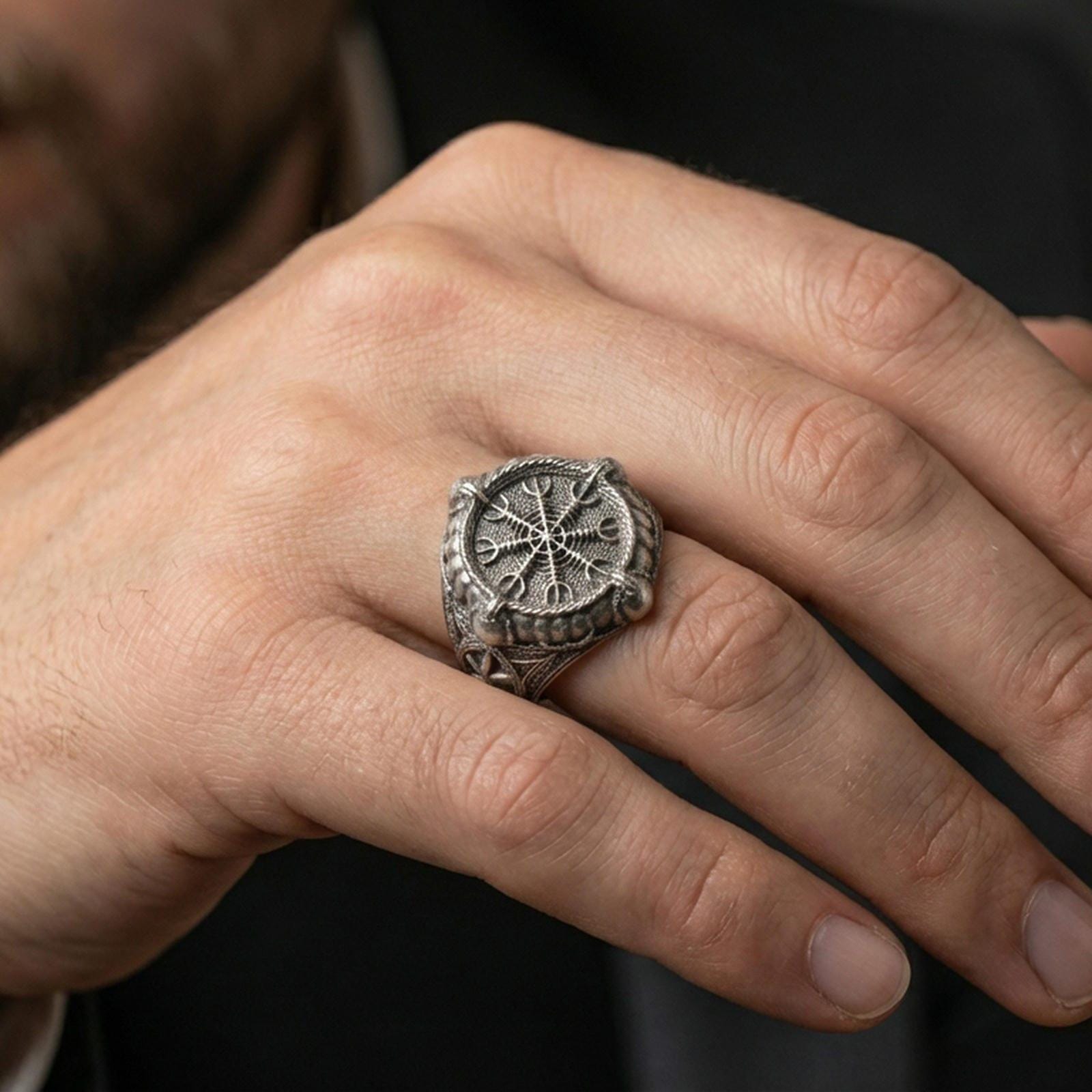 Sterling silver Vegvisir Viking compass ring in an oxidized finish worn on finger, Norse protection symbol centered, lifestyle close-up