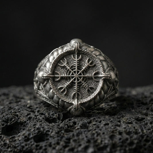 Sterling silver Vegvisir Viking compass signet ring in an oxidized finish on volcanic rock, Nordic protection symbol, macro studio shot