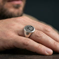 Load image into Gallery viewer, Oxidized finish Yggdrasil world tree ring on hand, signet profile and engraved face detail, minimalist lifestyle shot
