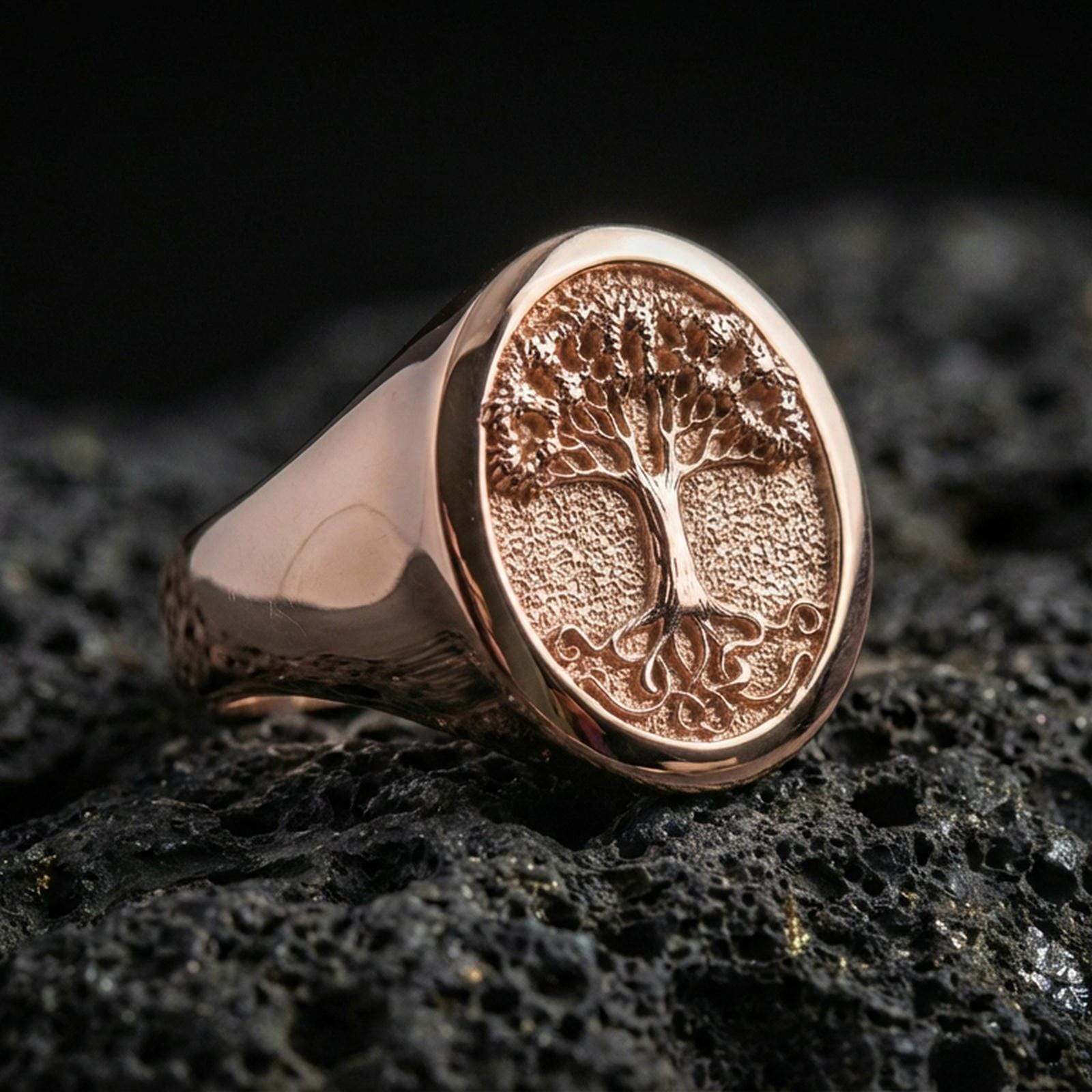 Yggdrasil signet ring in rose gold finish on volcanic rock, bold Tree of Life symbol, luxury studio close-up