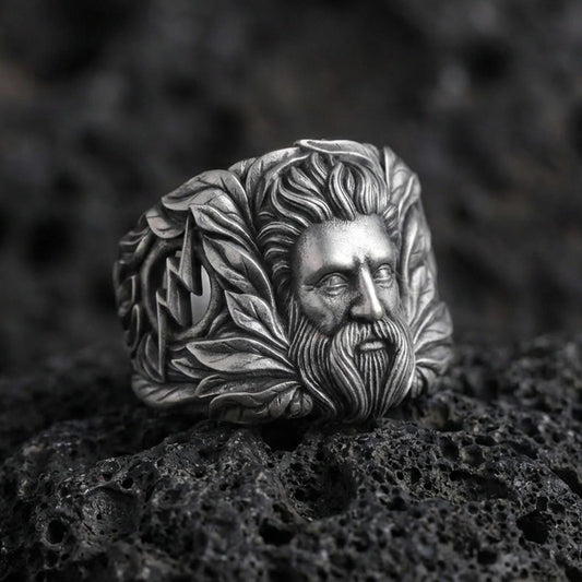 Zeus sterling silver ring with Greek god portrait and laurel details on volcanic rock, oxidized finish macro photo