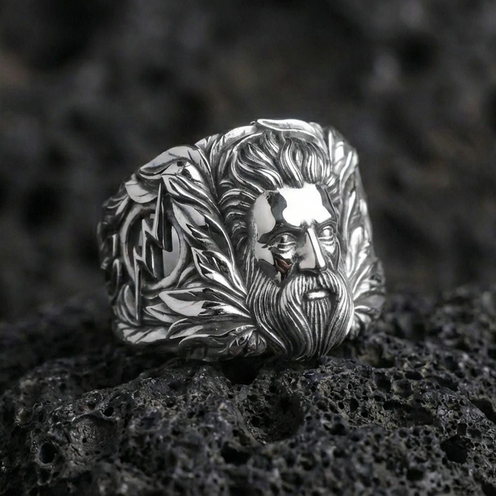 Greek Zeus head ring in sterling silver on volcanic rock, polished silver finish, detailed beard relief close-up