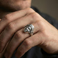 Load image into Gallery viewer, Polished silver Venus ring on finger showcasing sculpture-inspired face and detailed hair texture, clean lifestyle wear photo
