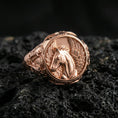 Load image into Gallery viewer, Rose gold plated Pegasus ring showcasing elegant winged horse motif and refined engraving, sharp close-up product photography on volcanic rock
