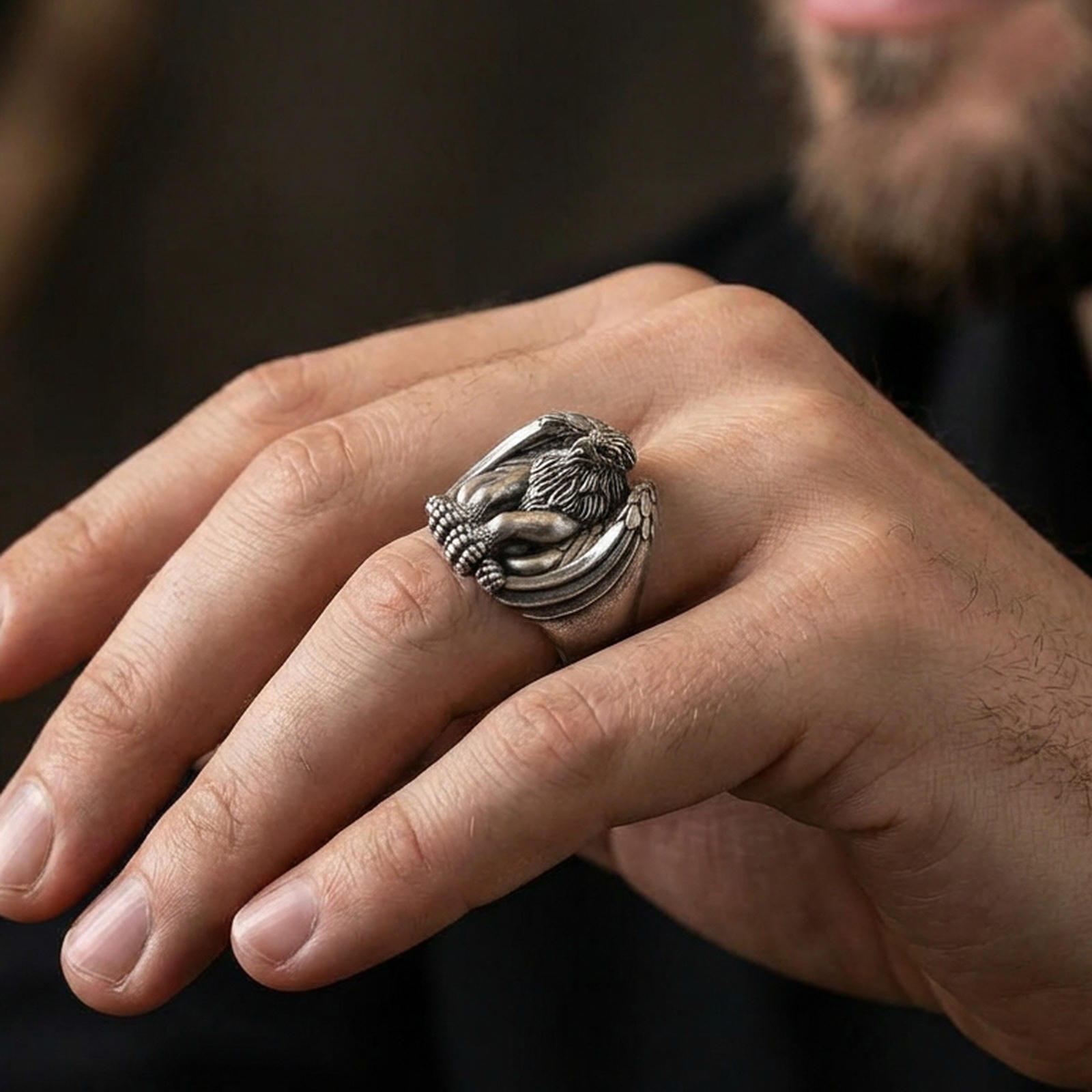 Oxidized sterling silver griffin guardian ring worn on finger, protective mythical beast design symbolizing strength and guidance, masculine lifestyle hand shot
