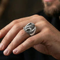 Load image into Gallery viewer, Polished silver griffin signet ring on finger highlighting detailed wings and lion paws, clean lifestyle wear photo
