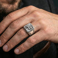 Load image into Gallery viewer, Polished silver gryphon signet ring on finger highlighting sunburst background and detailed creature relief, clean lifestyle wear photo

