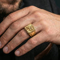 Load image into Gallery viewer, Gold plated gryphon ring worn on finger, statement Greek myth jewelry with ornate engraved band, premium lifestyle close-up
