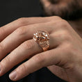 Load image into Gallery viewer, Rose gold plated Foo Dog ring on finger featuring fierce guardian lion head and decorative carving, refined lifestyle jewelry wear shot
