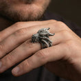 Load image into Gallery viewer, Oxidized sterling silver dragon wyrm ring worn on finger, bold horned dragon head with scale texture, masculine lifestyle hand shot
