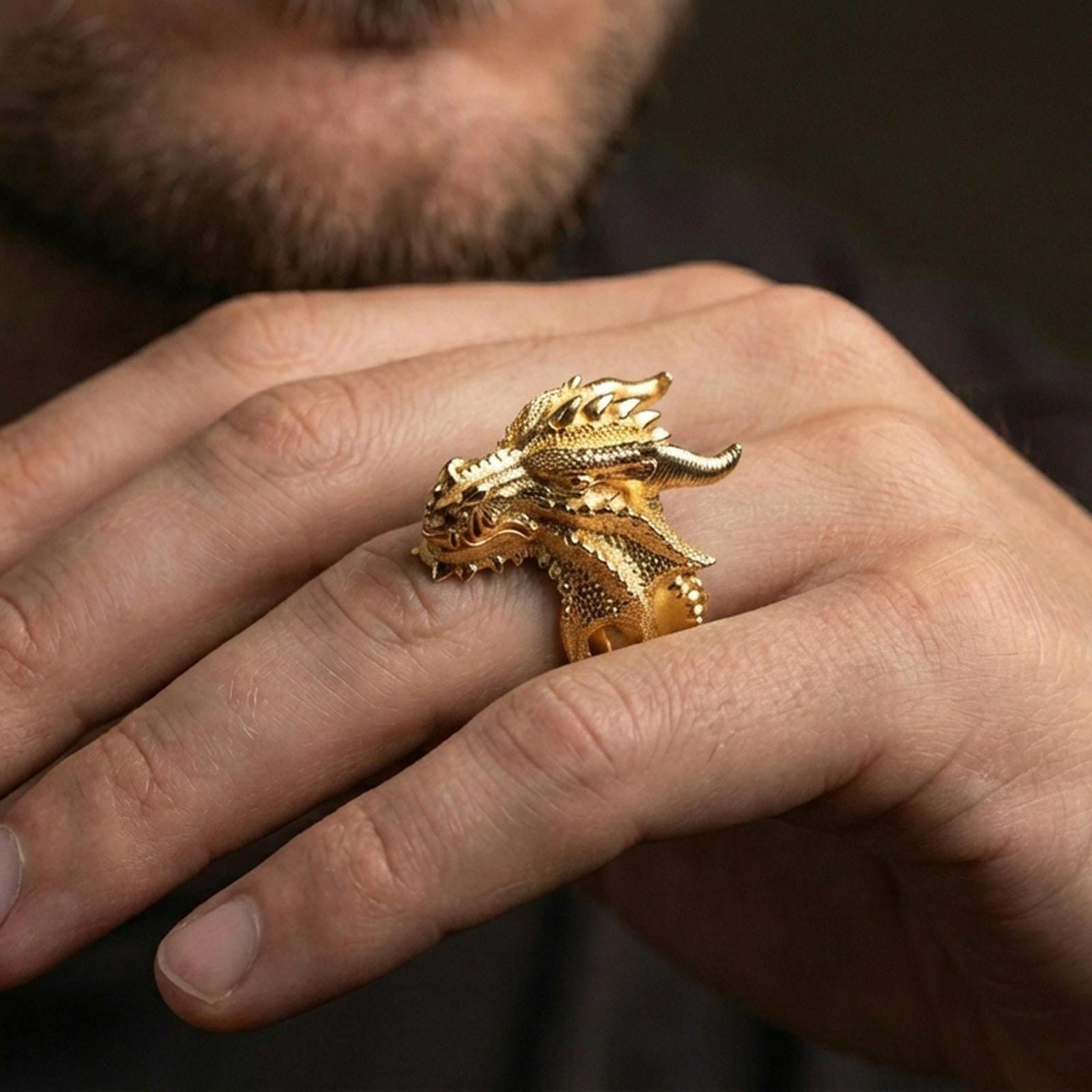 Gold plated dragon wyrm statement ring worn on finger, fantasy jewelry inspired by mythical dragons and ancient legends, premium lifestyle close-up