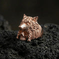 Load image into Gallery viewer, Rose gold plated wolf headdress skull ring on black volcanic stone, wolf head and skull signet ring, dramatic fantasy aesthetic
