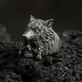 Load image into Gallery viewer, Oxidized sterling silver wolf headdress skull ring on black volcanic stone, tribal warrior wolf head over skull, dark fantasy signet
