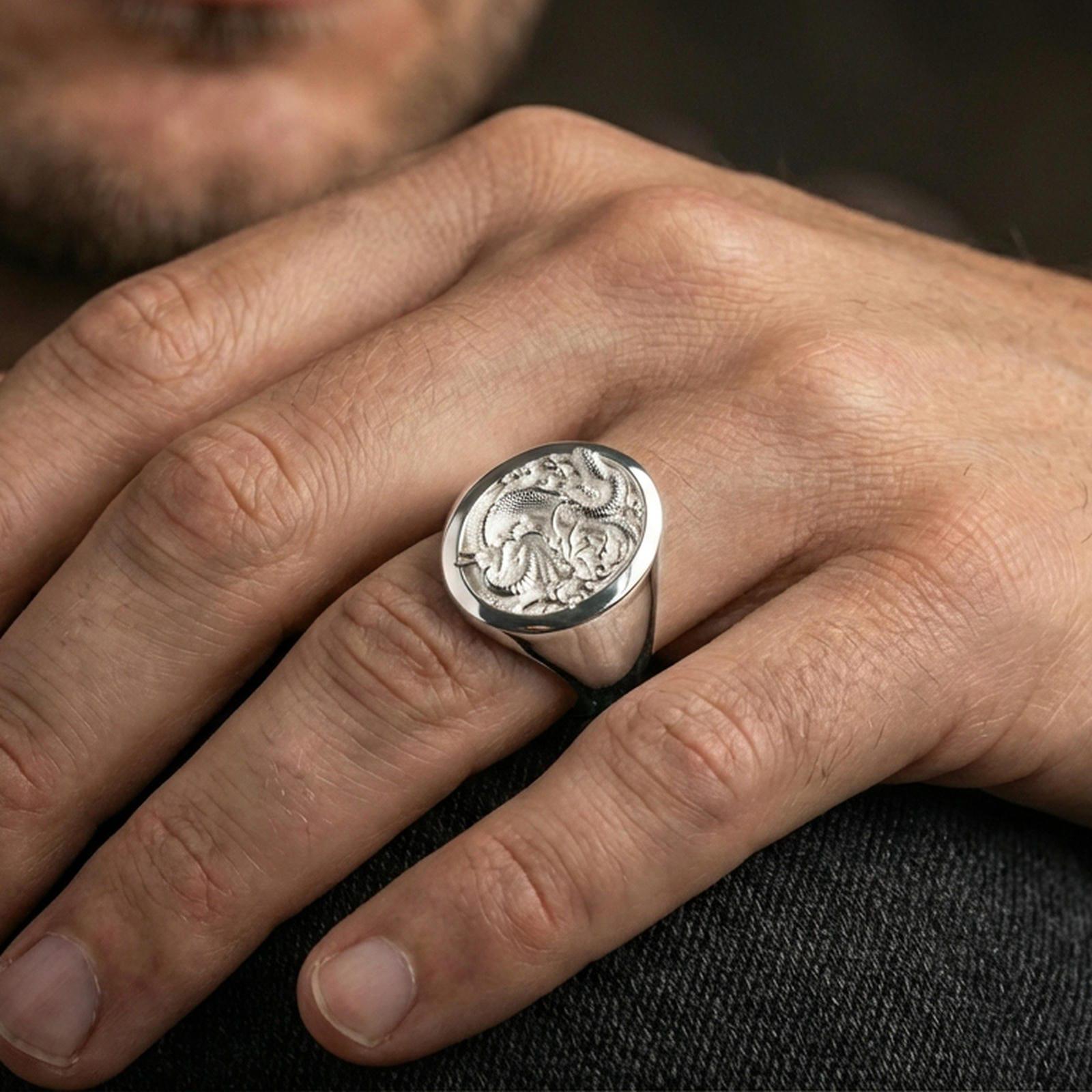 Polished sterling silver Chinese dragon signet ring on a human finger, detailed dragon scales and clouds, classic signet style