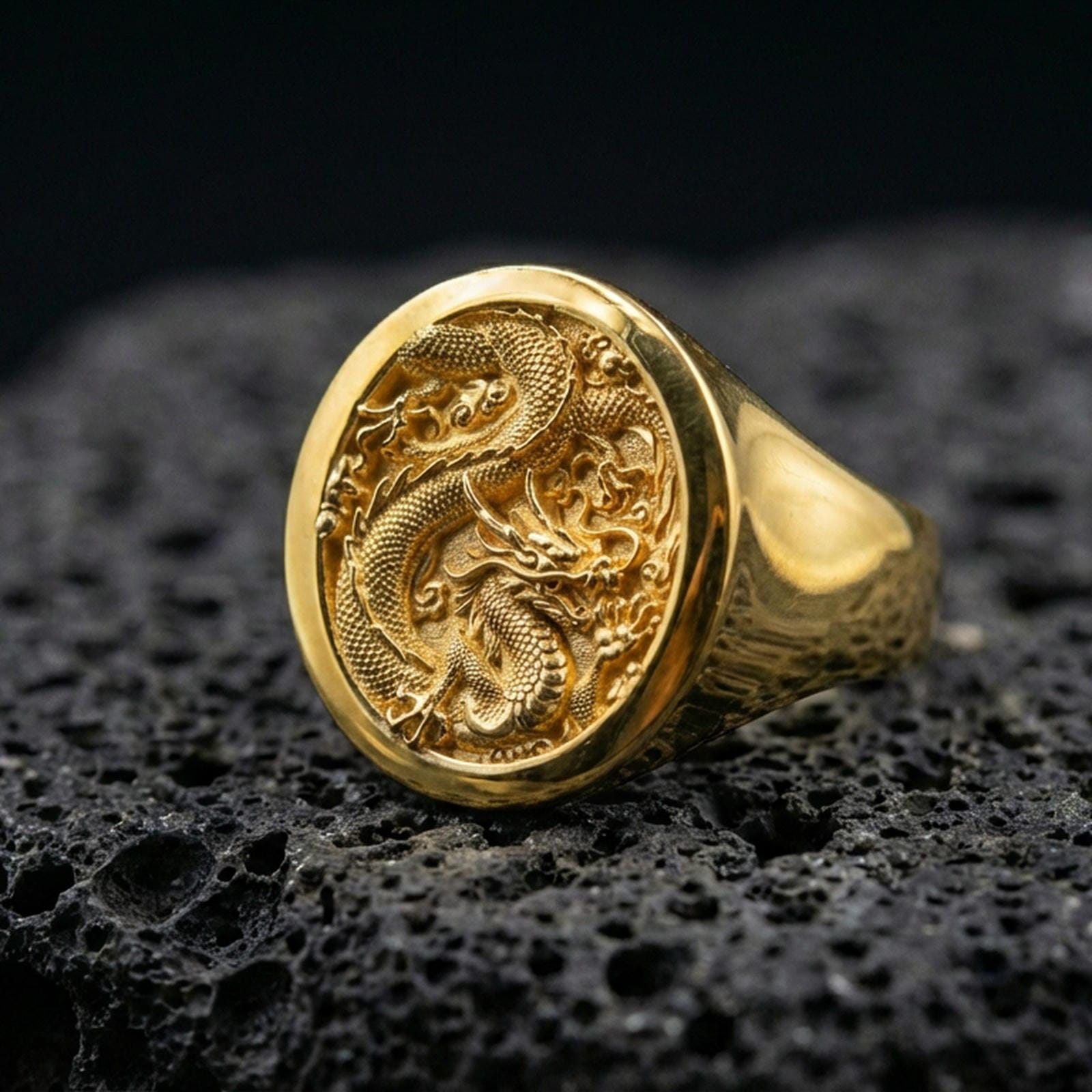 Gold plated Chinese dragon signet ring on black volcanic stone, traditional dragon motif, lucky protector symbol jewelry