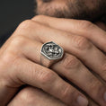 Load image into Gallery viewer, Oxidized sterling silver dragon ring on a human finger, winged dragon relief, dark fantasy gothic styling
