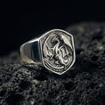 Load image into Gallery viewer, Polished sterling silver dragon signet ring on black volcanic stone, detailed winged dragon engraving, bold fantasy accessory
