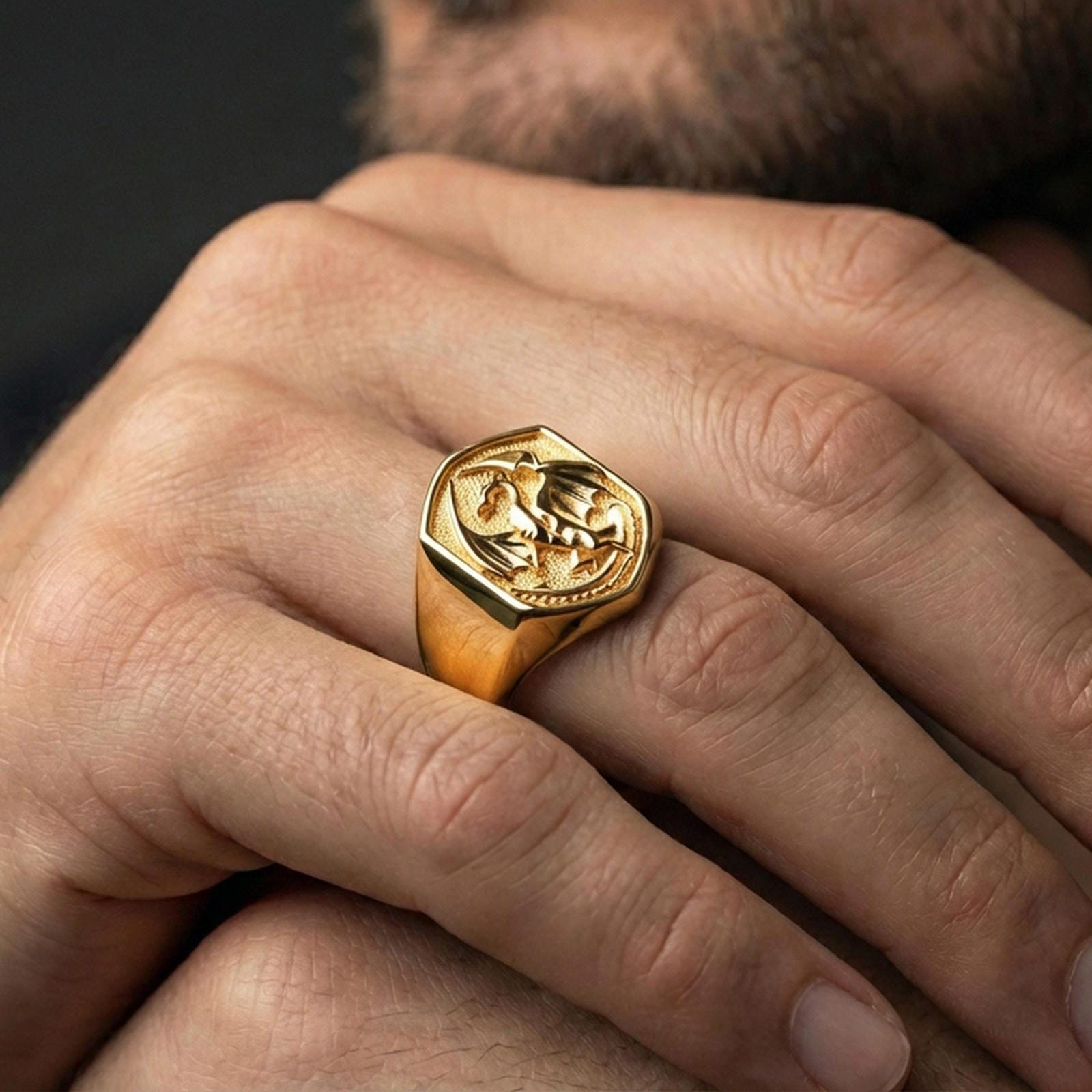 Gold plated dragon ring on a human finger, winged dragon fantasy accessory, bold mythologic jewelry style