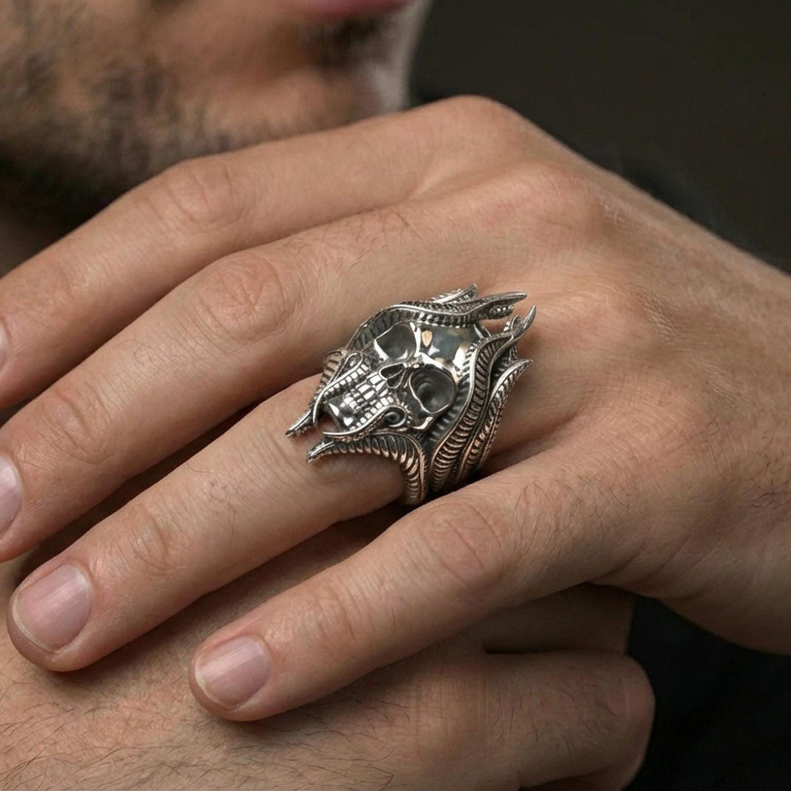 Polished sterling silver lich skull ring on a human finger, detailed skull ring, D&D fantasy jewelry