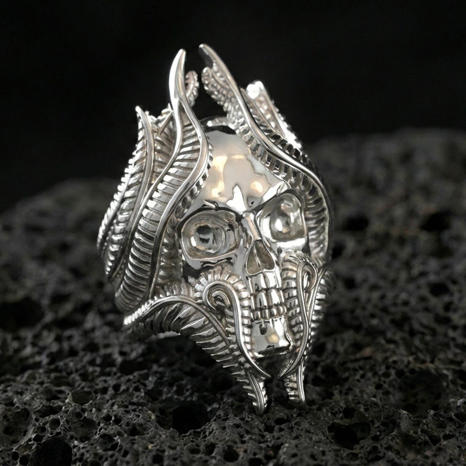 Polished sterling silver lich skull ring on black volcanic stone, intricate skull and tendril design, D&D inspired ring
