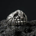 Load image into Gallery viewer, Oxidized sterling silver dragon skull ring on black volcanic stone, dragon perched over skull pile, gothic fantasy signet
