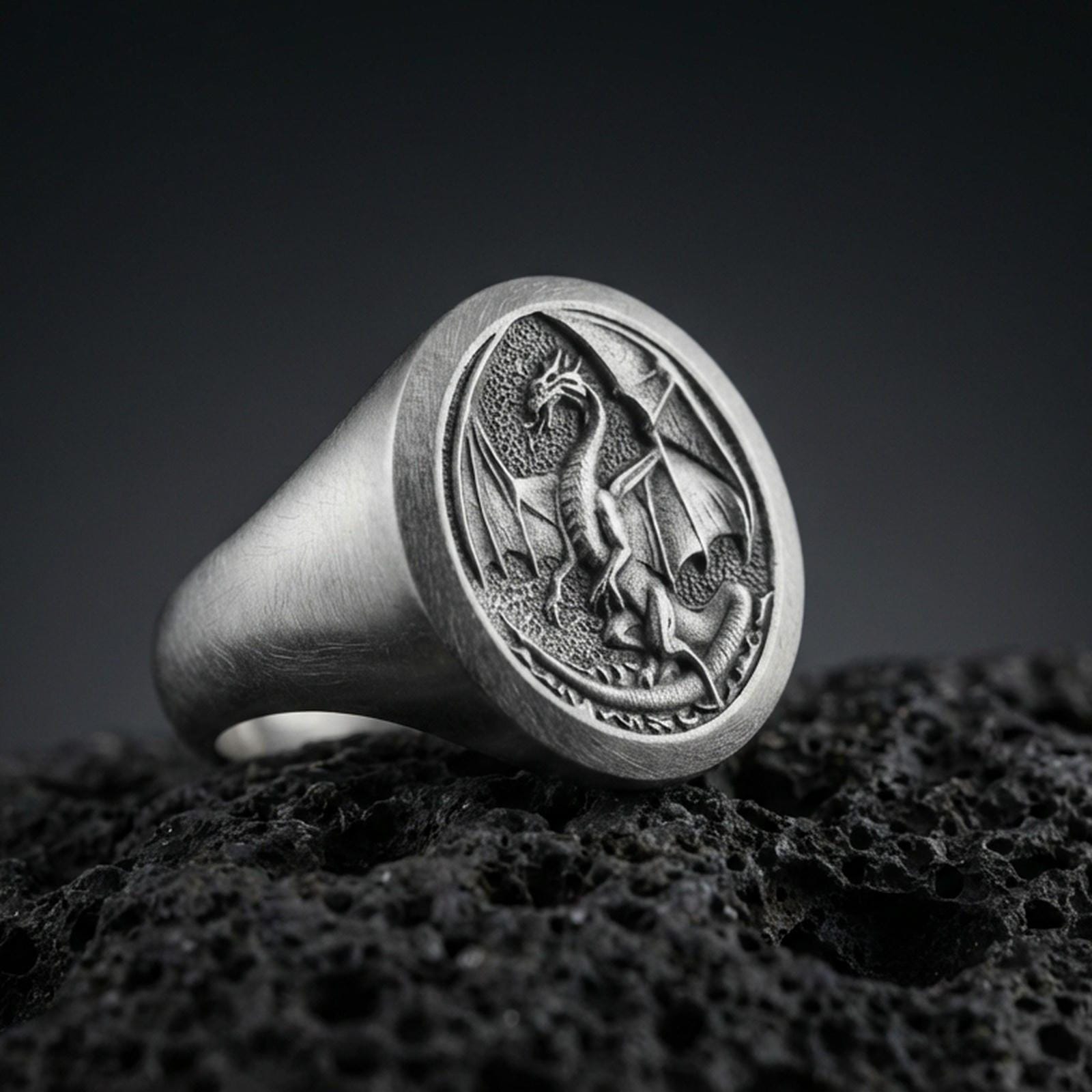 Oxidized sterling silver dragon signet ring on black volcanic stone, medieval winged dragon relief, fantasy statement ring