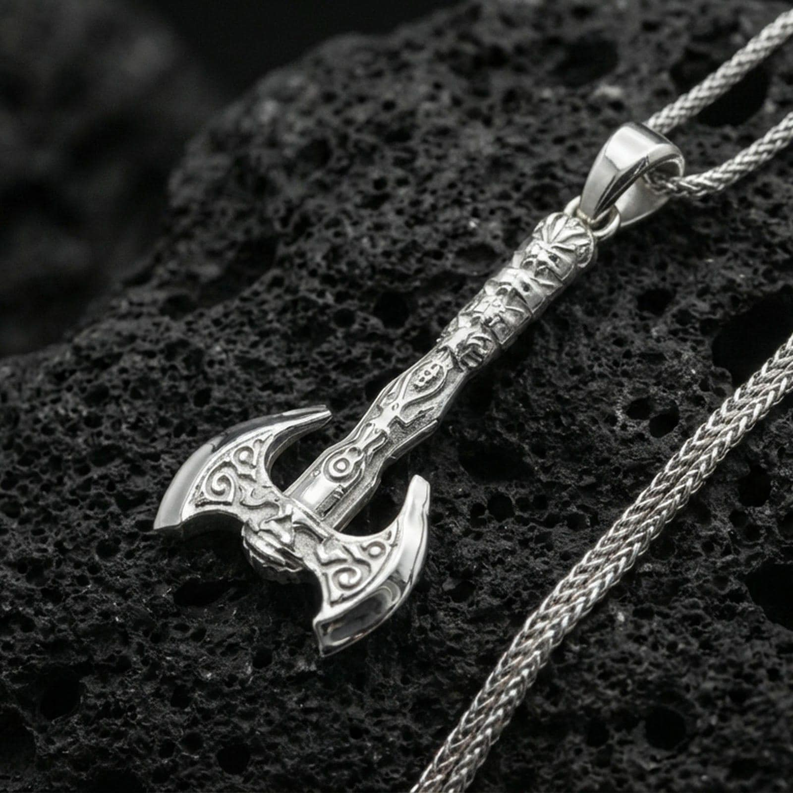 Polished sterling silver Viking labrys axe necklace pendant on black volcanic stone, detailed warrior axe charm, braided chain