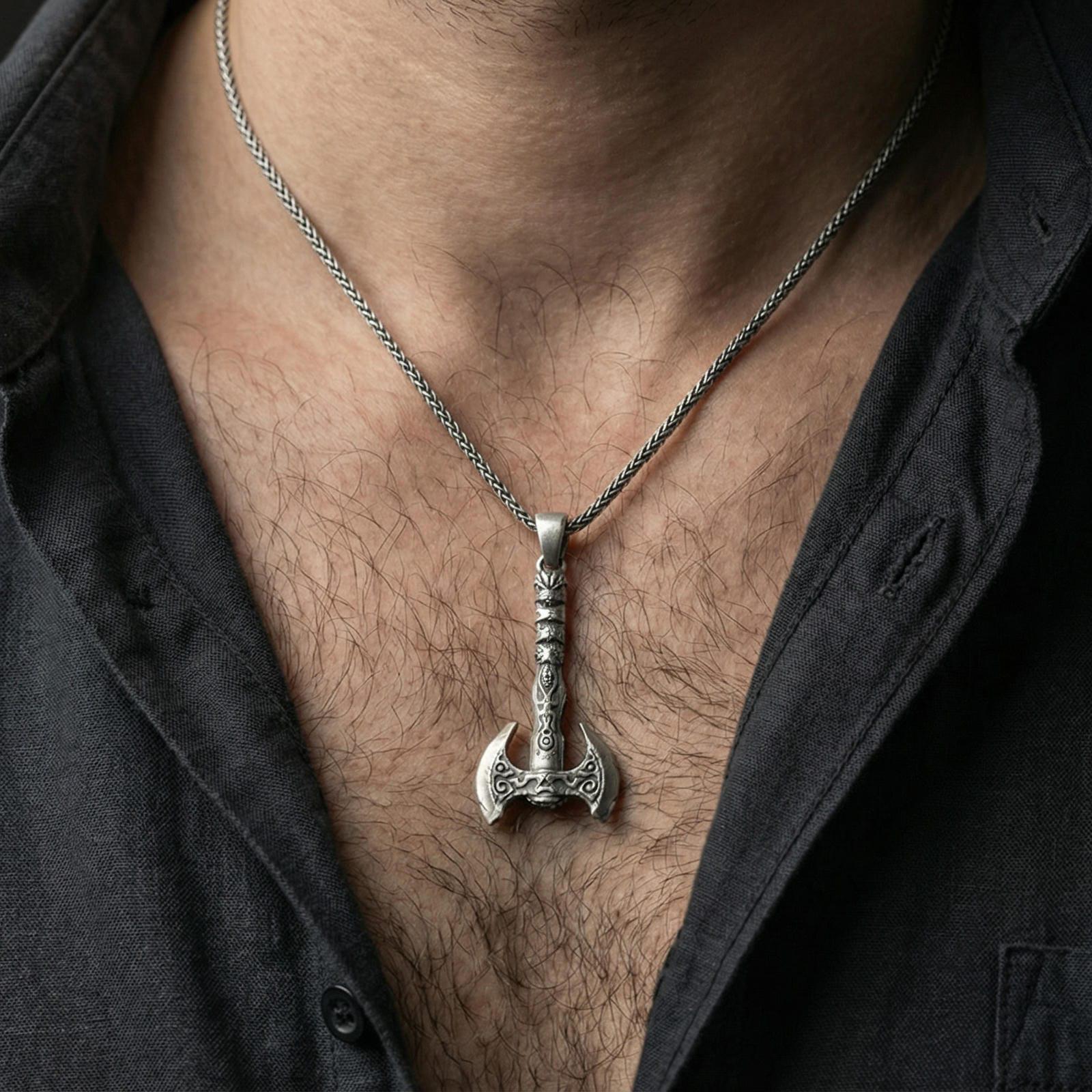Oxidized sterling silver Viking labrys axe necklace pendant worn on a human neck, double-headed axe motif, braided chain