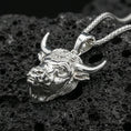 Load image into Gallery viewer, Polished sterling silver bull head necklace pendant on black volcanic stone, Taurus zodiac horned bull charm, braided chain
