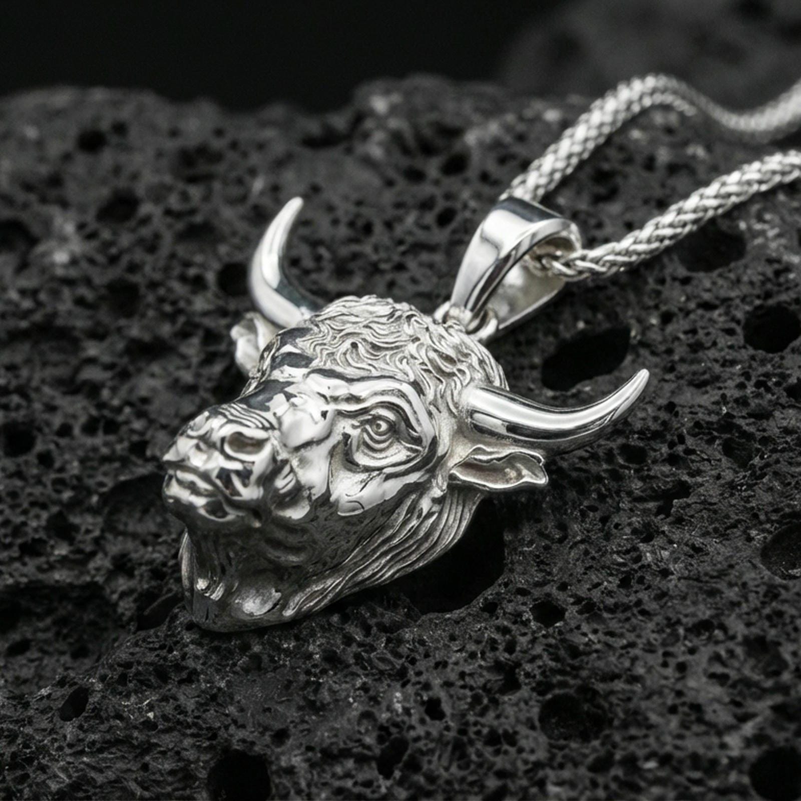Polished sterling silver bull head necklace pendant on black volcanic stone, Taurus zodiac horned bull charm, braided chain