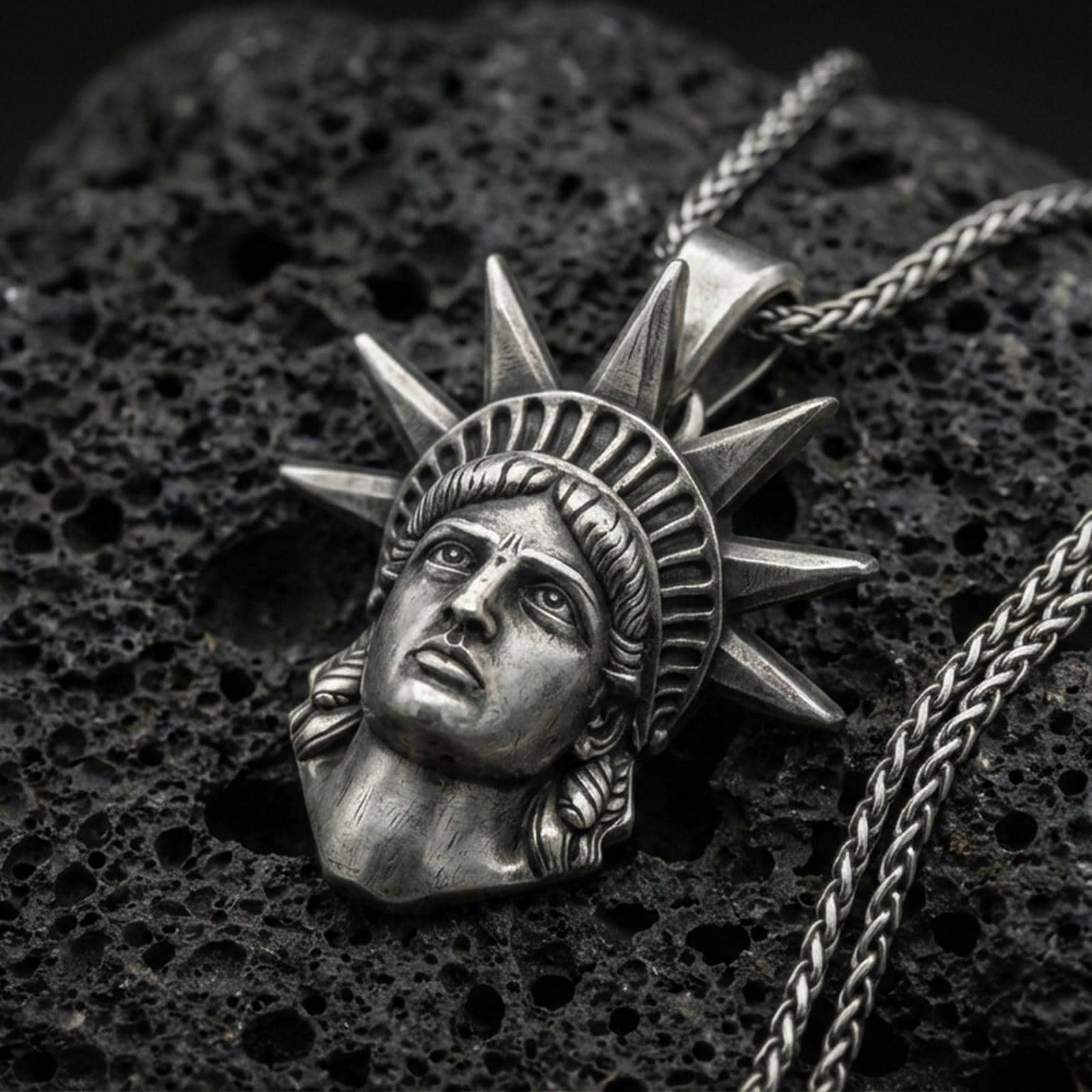 Oxidized sterling silver Statue of Liberty pendant on black volcanic stone, NYC skyline charm, braided chain necklace