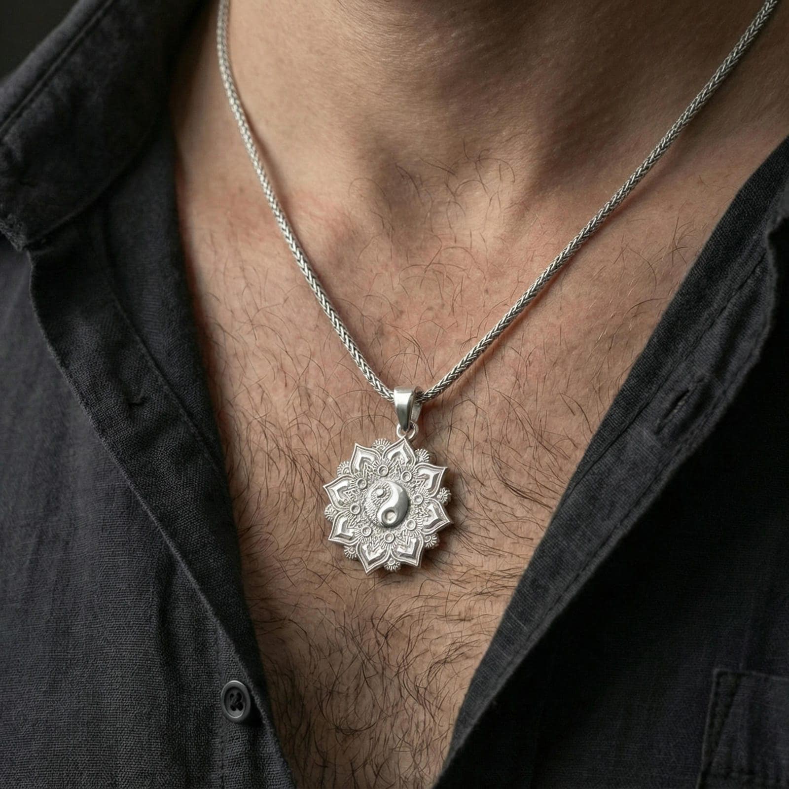 Polished sterling silver yin yang mandala pendant on a human neck, balance harmony talisman, braided chain necklace