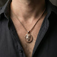Load image into Gallery viewer, Rose gold plated memento mori coin pendant worn on neck, detailed relief centerpiece, clean lifestyle framing with dark shirt contrast

