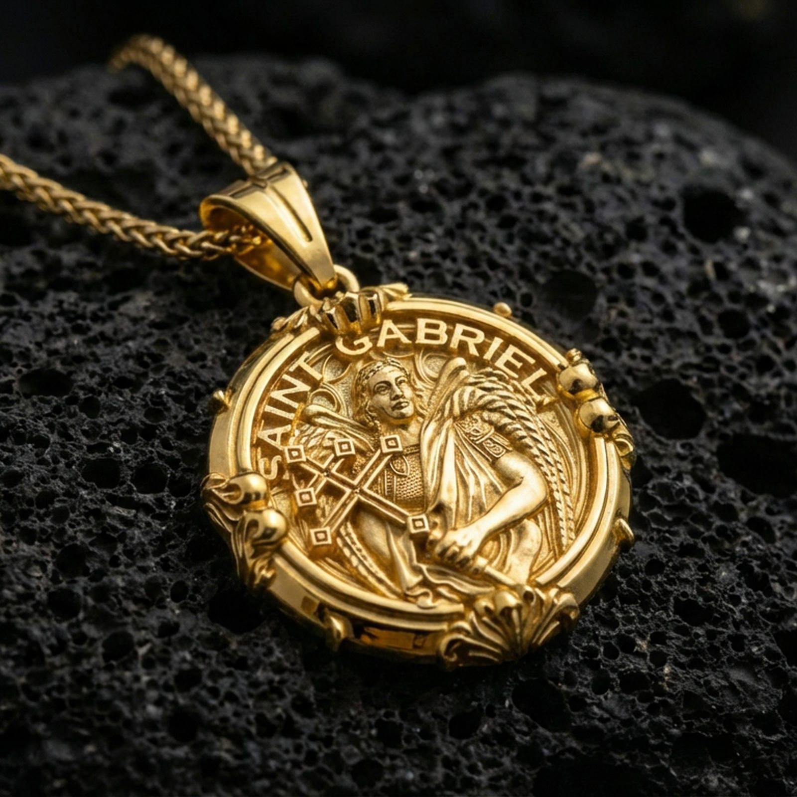 Gold plated Saint Gabriel pendant on porous volcanic rock backdrop, archangel messenger design with cross centerpiece, premium product photo