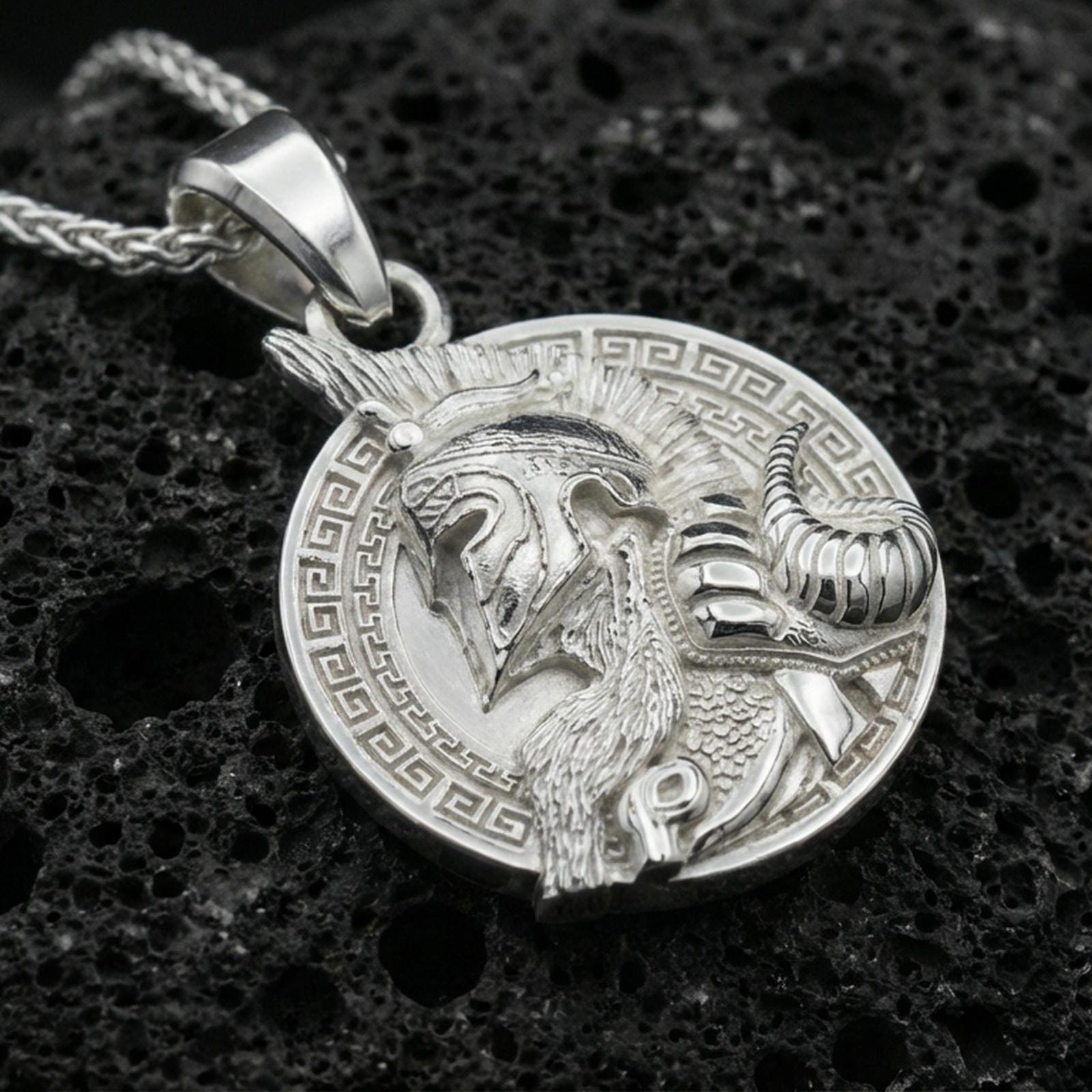 Polished silver Norse warrior medallion necklace on dark volcanic stone, detailed helmet and beard engraving, premium close-up composition