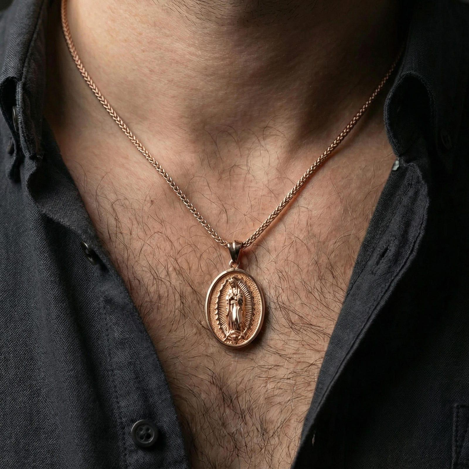 Rose gold plated Guadalupe oval pendant worn on neck, detailed Virgin Mary relief, clean lifestyle framing with dark shirt contrast
