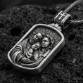 Load image into Gallery viewer, Oxidized sterling silver Holy Family pendant on textured volcanic rock, rectangular medallion with Mary Joseph and Child relief, macro studio shot
