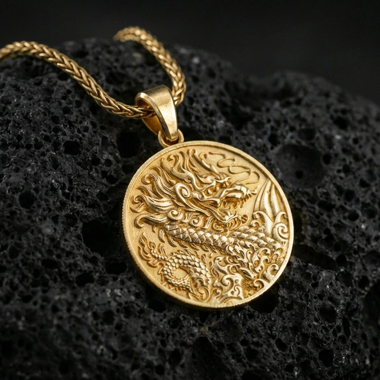 Gold plated Chinese dragon round pendant on porous volcanic rock backdrop, bold dragon design with ornate linework, high-contrast lighting