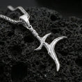 Load image into Gallery viewer, Polished silver black knife dagger pendant on porous volcanic stone, minimal blade charm necklace with wrapped handle, close-up
