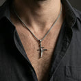 Load image into Gallery viewer, Oxidized sterling silver black knife charm necklace worn on neck, Elden Ring inspired dagger pendant on braided chain, dark lifestyle shot
