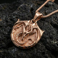 Load image into Gallery viewer, Rose gold plated dragon pendant on volcanic rock, fantasy warrior amulet necklace with detailed dragon crest
