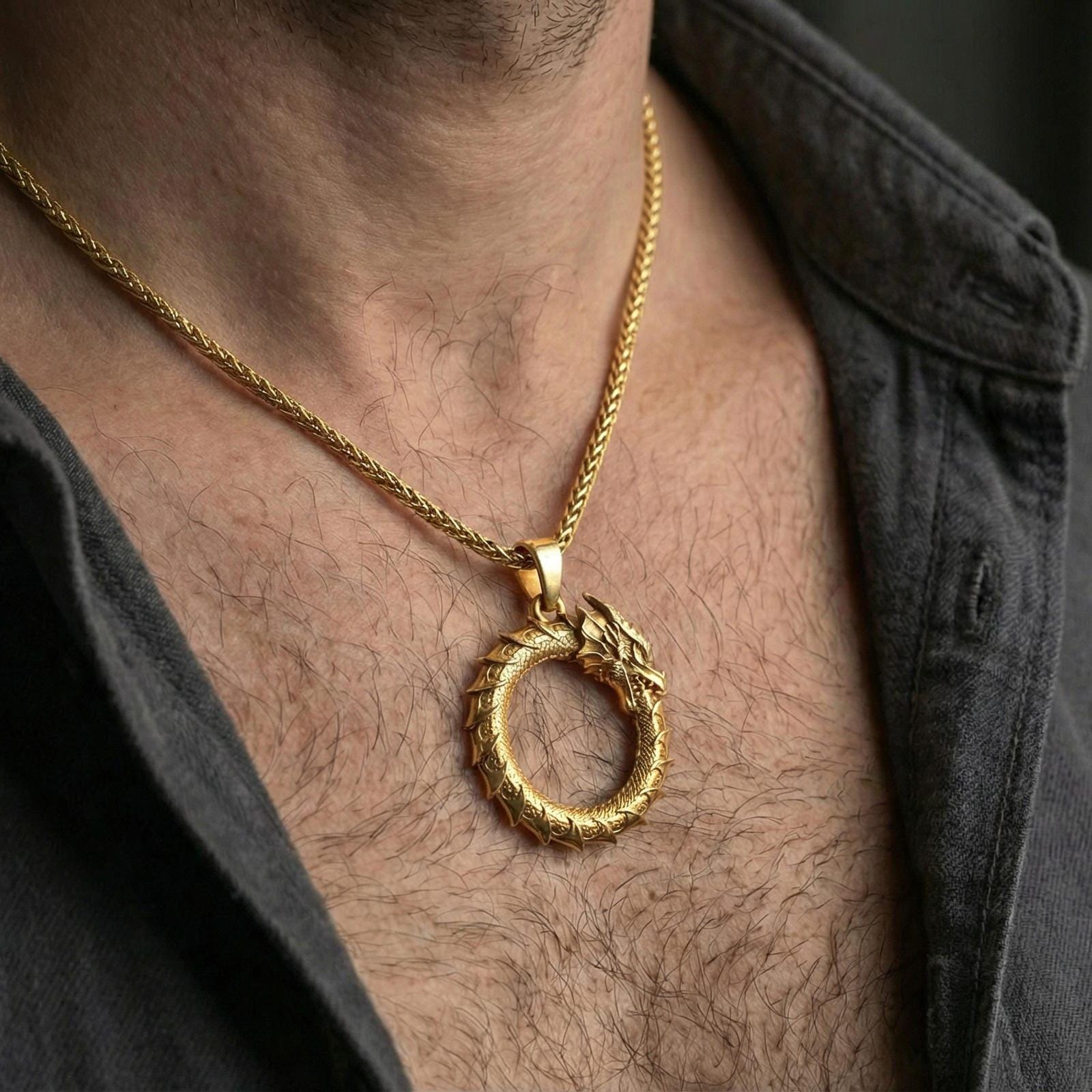 Gold plated ouroboros dragon pendant worn on neck, cosmic eternity symbol necklace centered on chest, premium lifestyle framing